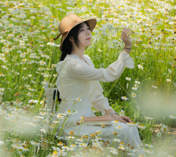 Asian woman painting in garden